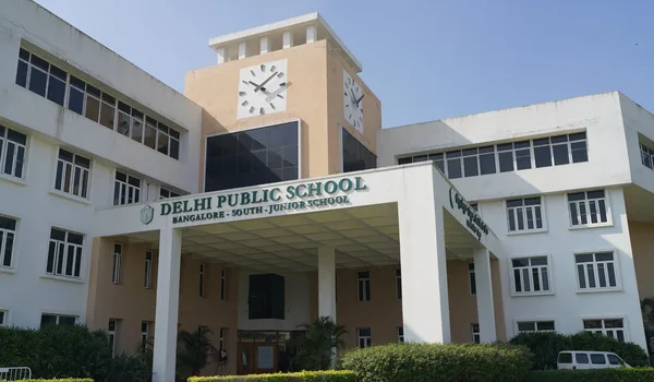 Delhi Public School Bangalore South, Bangalore — junior school building with its clock tower and the school name board over the entrance colonnade
