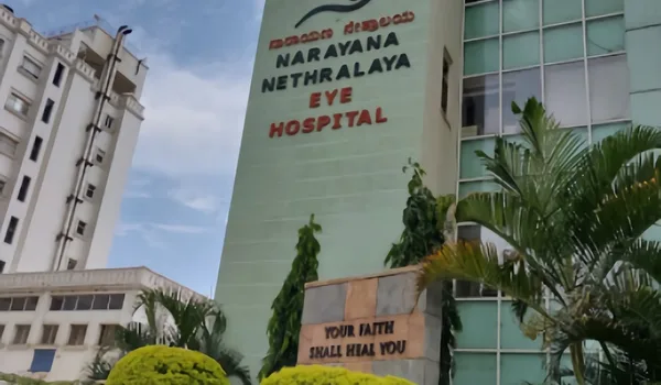 Narayana Nethralaya Eye Hospital, Bangalore — green-clad hospital tower with the Narayana Nethralaya Eye Hospital lettering in Kannada and English on its facade