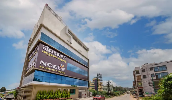 Noble Multispeciality Hospitals, Bangalore — glass-fronted hospital building with the hospital name in Kannada and English on its street elevation